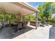 Covered patio with hot tub and outdoor dining area at 10452 Acclamato Ave, Las Vegas, NV 89135