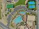 Aerial view of a community pool, tennis courts, a basketball court, and ample parking at 1067 Via Saint Andrea Pl, Henderson, NV 89011