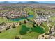 Picturesque aerial view showcasing a lush golf course community with scenic ponds and fairways at 1067 Via Saint Andrea Pl, Henderson, NV 89011