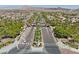 Stunning aerial view of a gated community entrance with manicured landscaping and palm tree lined streets at 1067 Via Saint Andrea Pl, Henderson, NV 89011