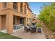 Inviting back patio with an outdoor kitchen, firepit, lounge chairs, and a pool table at 1067 Via Saint Andrea Pl, Henderson, NV 89011