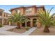 Inviting two-story home featuring a covered entryway with columns and desert landscaping at 1067 Via Saint Andrea Pl, Henderson, NV 89011