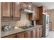 Beautiful kitchen featuring granite countertops, a tiled backsplash, and stainless steel appliances at 1067 Via Saint Andrea Pl, Henderson, NV 89011