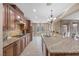 Well-equipped kitchen with granite countertops, tile backsplash, and a view of the backyard at 1067 Via Saint Andrea Pl, Henderson, NV 89011