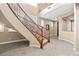 Elegant staircase with wooden railings and tile flooring leads to the upper level at 1067 Via Saint Andrea Pl, Henderson, NV 89011