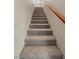 Carpeted staircase ascending with a wooden handrail provides access to the upper levels at 1067 Via Saint Andrea Pl, Henderson, NV 89011