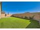 Backyard featuring artificial turf and a brick wall at 10923 Stone Crossing Ave, Las Vegas, NV 89166