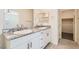 Bathroom featuring double sinks, white cabinets, and granite countertop at 10923 Stone Crossing Ave, Las Vegas, NV 89166