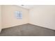 Bedroom with window, neutral carpet, and ample natural light at 10923 Stone Crossing Ave, Las Vegas, NV 89166