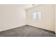 Bedroom featuring neutral carpet, window with blinds, and ample natural light at 10923 Stone Crossing Ave, Las Vegas, NV 89166