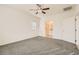 Neutral Primary bedroom with ceiling fan, carpet, and ensuite bathroom at 10923 Stone Crossing Ave, Las Vegas, NV 89166