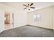 Spacious bedroom features a ceiling fan, window with blinds, and neutral carpet at 10923 Stone Crossing Ave, Las Vegas, NV 89166