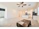 Open floor plan with living room and kitchen area, with tile flooring and a ceiling fan at 10923 Stone Crossing Ave, Las Vegas, NV 89166