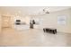 Living room flows into kitchen, featuring tile flooring and a ceiling fan at 10923 Stone Crossing Ave, Las Vegas, NV 89166