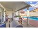 Inviting backyard with sparkling pool, patio cover, and BBQ area at 1144 Sage Valley Ct, Las Vegas, NV 89110