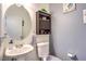 Small bathroom with pedestal sink, toilet and dark wood cabinet at 1144 Sage Valley Ct, Las Vegas, NV 89110