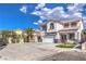 Two-story house with white exterior, red accents, and a two-car garage at 1144 Sage Valley Ct, Las Vegas, NV 89110