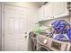 Laundry room with washer, dryer, and cabinets at 1144 Sage Valley Ct, Las Vegas, NV 89110