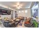 Living room with leather sectional sofa and open kitchen view at 1144 Sage Valley Ct, Las Vegas, NV 89110