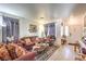 Living room with wood-look floors, neutral walls, and comfortable seating at 1144 Sage Valley Ct, Las Vegas, NV 89110