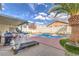 Relaxing poolside view with patio furniture and lush landscaping at 1144 Sage Valley Ct, Las Vegas, NV 89110