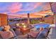 Sunset view of backyard with pool, firepit, and seating area at 12073 Glentana View St, Las Vegas, NV 89138