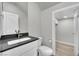 Modern bathroom with white vanity, dark countertop, and toilet at 12073 Glentana View St, Las Vegas, NV 89138