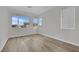 Bright bedroom with wood-look flooring and large windows at 12073 Glentana View St, Las Vegas, NV 89138