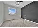 Cozy bedroom with grey accent wall and a window with a view at 12073 Glentana View St, Las Vegas, NV 89138