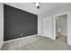 Spacious bedroom with grey accent wall and plush carpeting at 12073 Glentana View St, Las Vegas, NV 89138