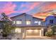 Two-story modern home with attached garage; sunset view at 12073 Glentana View St, Las Vegas, NV 89138