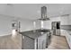 Modern kitchen with large island, stainless steel appliances, and white cabinets at 12073 Glentana View St, Las Vegas, NV 89138