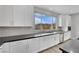 Modern kitchen with white cabinets, stainless steel appliances, and a large window at 12073 Glentana View St, Las Vegas, NV 89138