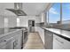 Modern kitchen with stainless steel appliances and breakfast bar at 12073 Glentana View St, Las Vegas, NV 89138