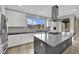 Modern kitchen with large island, stainless steel appliances, and white cabinets at 12073 Glentana View St, Las Vegas, NV 89138