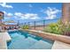 Inviting rectangular pool with a waterfall feature and patio furniture at 12073 Glentana View St, Las Vegas, NV 89138