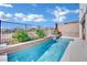 Modern, rectangular pool with a waterfall feature and a stone coping at 12073 Glentana View St, Las Vegas, NV 89138