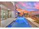 Modern pool and patio with a fire feature and sunset view at 12073 Glentana View St, Las Vegas, NV 89138