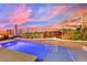 Luminous pool with a waterfall feature and lush landscaping at 12073 Glentana View St, Las Vegas, NV 89138