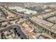 Aerial view of a house in a residential area with a pool, near shops and businesses at 1226 Sunfire St, Henderson, NV 89014