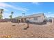 Spacious backyard with gravel and a covered patio at 1226 Sunfire St, Henderson, NV 89014