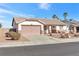 House exterior featuring a two-car garage and well-maintained landscaping at 1226 Sunfire St, Henderson, NV 89014