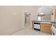 Kitchen with oak cabinets, white appliances and tile floor at 1226 Sunfire St, Henderson, NV 89014