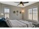 Bedroom featuring a ceiling fan, mountain views, and natural light from the windows at 12898 Slipknot St, Las Vegas, NV 89141