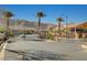 Gated community entrance with palm trees, mature landscaping and views of surrounding mountains at 12898 Slipknot St, Las Vegas, NV 89141