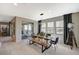 Dining room with a rustic wooden table, modern black chairs, and access to the backyard at 12898 Slipknot St, Las Vegas, NV 89141