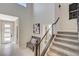 Inviting foyer features a modern staircase, tiled floors, and stylish decor at 12898 Slipknot St, Las Vegas, NV 89141