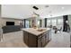 Open concept kitchen with a large kitchen island, modern light fixture, and barstool seating at 12898 Slipknot St, Las Vegas, NV 89141