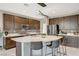 Modern kitchen with stainless steel appliances, stone countertops, and a large island with seating at 12898 Slipknot St, Las Vegas, NV 89141