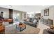 Bright living room with leather couches, fireplace, and access to the patio through sliding glass doors at 12898 Slipknot St, Las Vegas, NV 89141